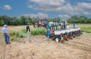 autonomous farm implement with farmers in a field