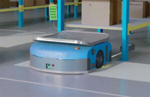 image of a warehouse robot in a warehouse aisle on a capow charging pad.