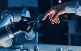 robot gripper touches the finger of a human hand.