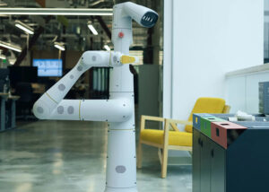 A white, tall everyday robots robot with a robotic arm.